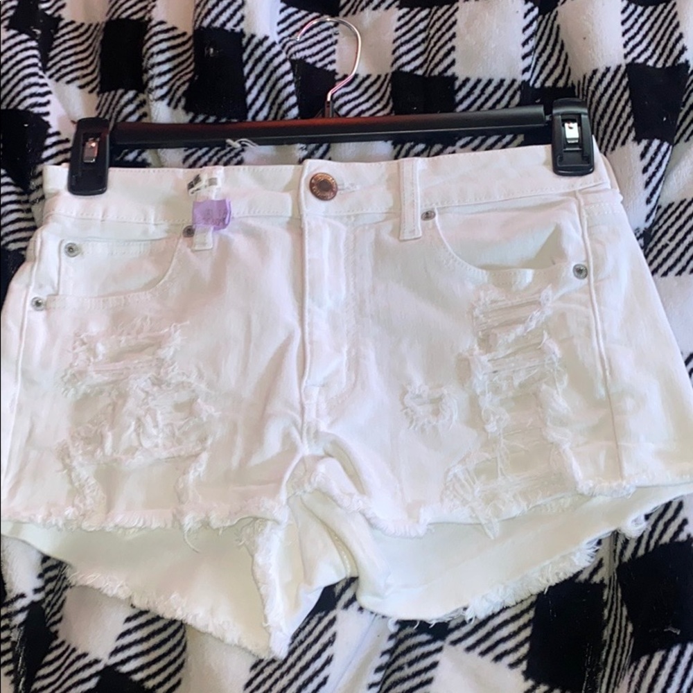 white ripped american eagle shorts